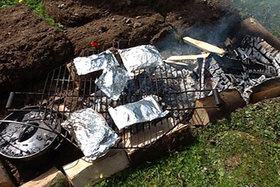 foil patties cooking on open fire