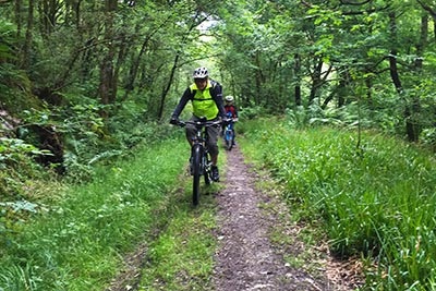 man on a mountain bike on a grassy track comming towards you