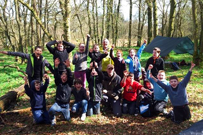 group of kids in an open wood setting